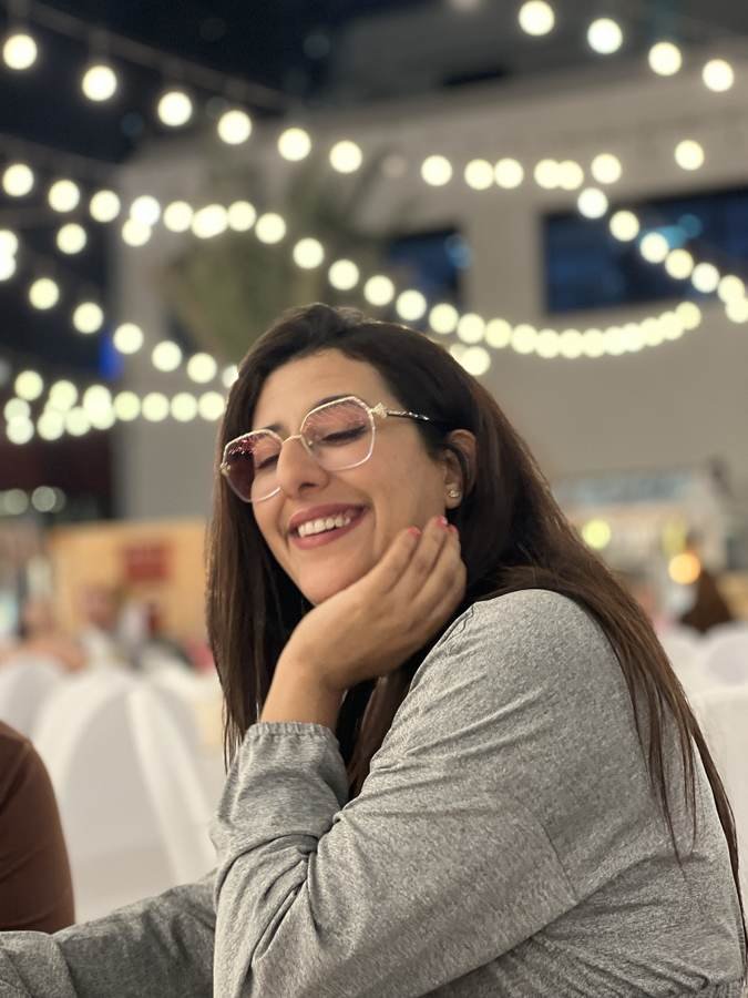 mid-laugh under the string lights