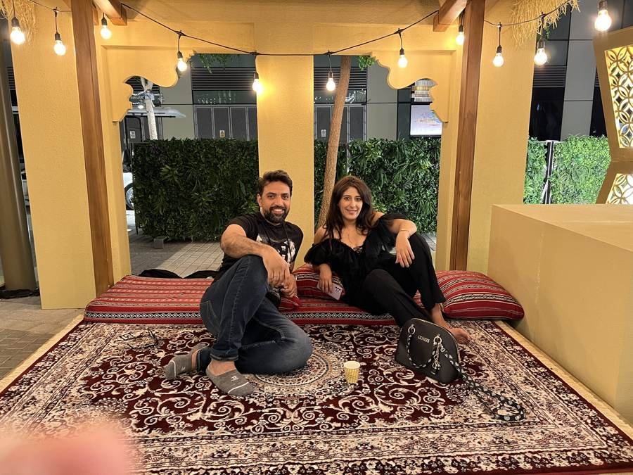 on the carpet under string lights