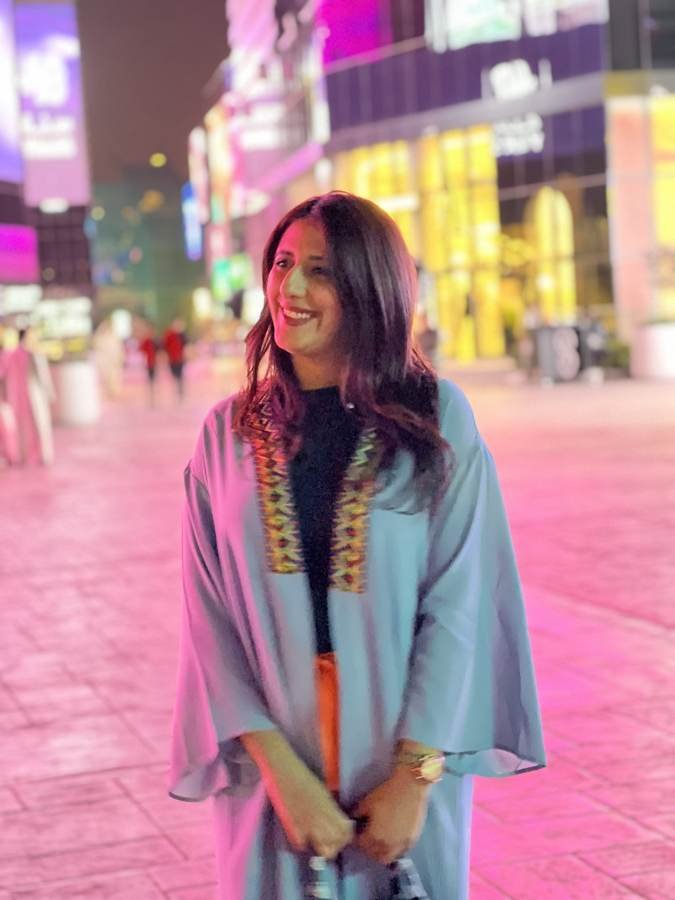 pink-lit street, big smile