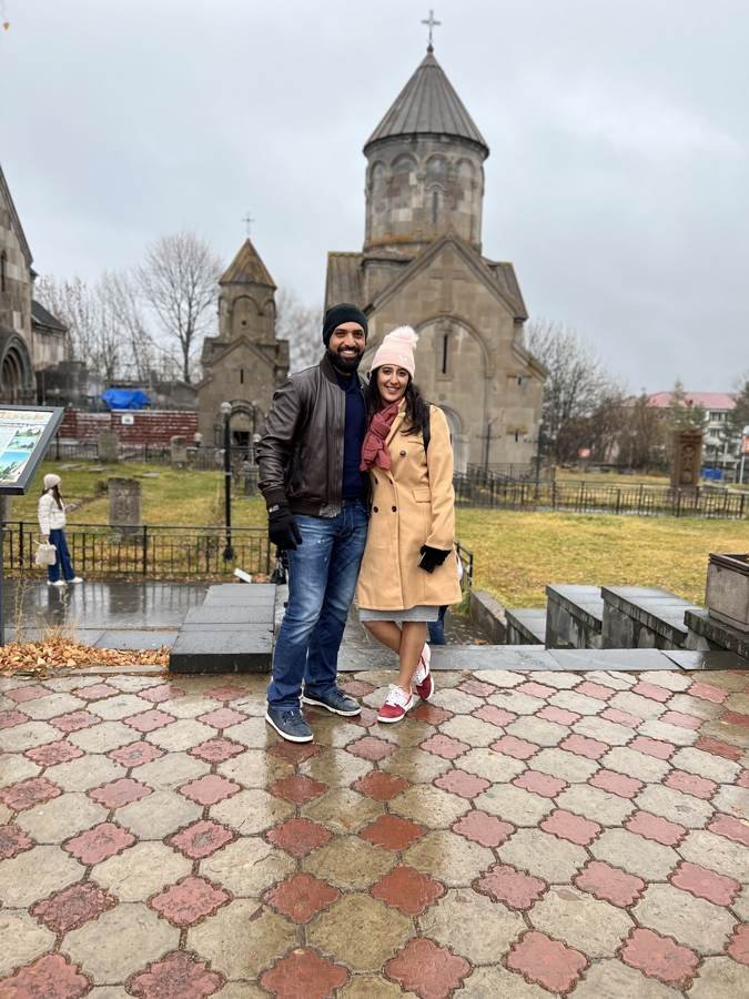 a rainy courtyard and an old stone church